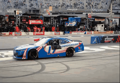 Race Car On Track With Pilot Sign GIF