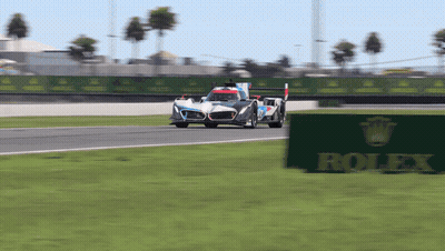 Race Car On Track With Rolex Sign GIF