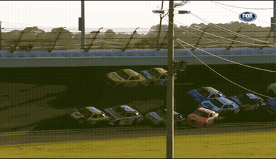 Race Cars Lined Up Under Bridge With Fox Sign GIF