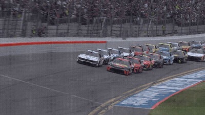 Race Cars On A Track With A 500 Sign In The Background GIF