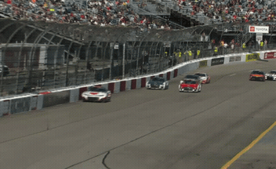 Race Cars Racing Past Yellow DHL Sign GIF