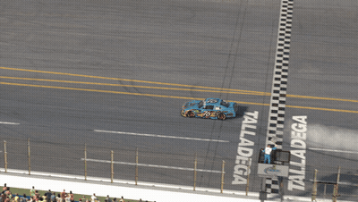 Race Track With Geico Sign GIF