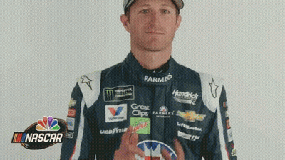 Racing Suit Man Flipping Bird In Front Of NASCAR Logo GIF