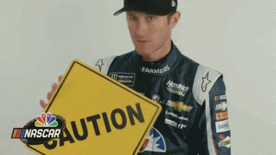 Racing Suit Man Flipping Bird In Front Of NASCAR Logo GIF