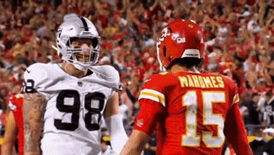 Raiders And Chiefs Football Players Standing GIF
