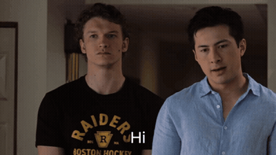 Raiders Shirt Man Next To Blue Shirt Man GIF