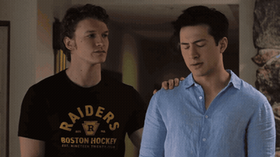 Raiders Shirt Man Next To Blue Shirt Man GIF