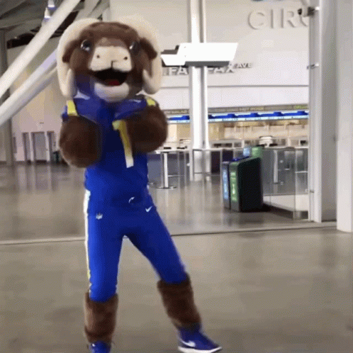 Ram Mascot Standing Before Cir GIF
