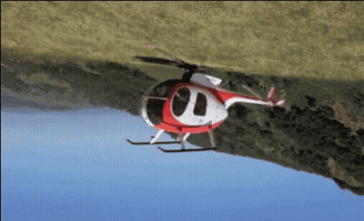 Red and White Helicopter Flying Over Grassy Hill