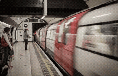 Red And White Train Pulling Into Station With People On Platform GIF
