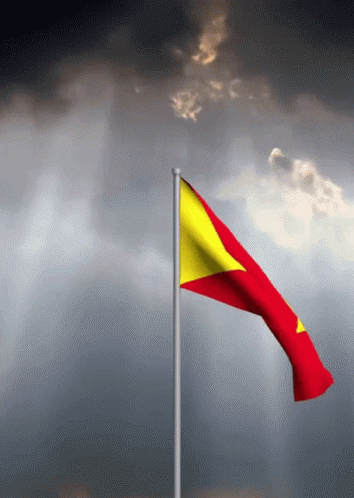 Red And Yellow Flag Waving On Cloudy Sky GIF