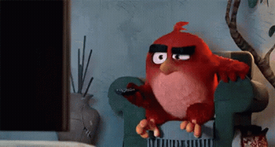 Red Angry Bird On Chair Holding Remote GIF