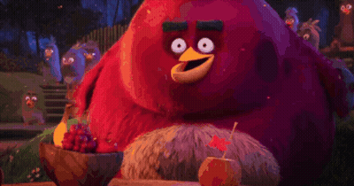 Red Angry Bird Sitting Next To Bowl Of Grapes And Apple GIF