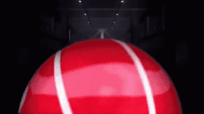 Red Ball With White Stripes Spinning In Dark Room GIF
