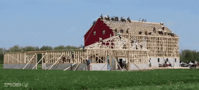 Red Barn Being Built In Field GIF