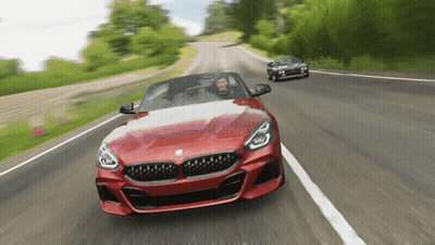 Red BMW Sports Car Driving Down Road GIF