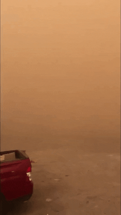 Red Car Barely Visible In Dust Storm GIF