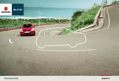 Red Car Driving Down Curvy Road With Suzuki Logo GIF