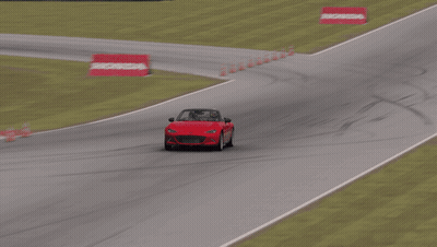 Red Car Driving Down Race Track With Houston Sign GIF