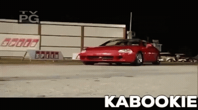 Red Car Driving Down Road With Kabookie GIF