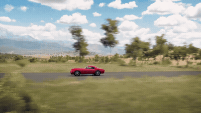 Coche rojo conduciendo por carretera con árboles GIF