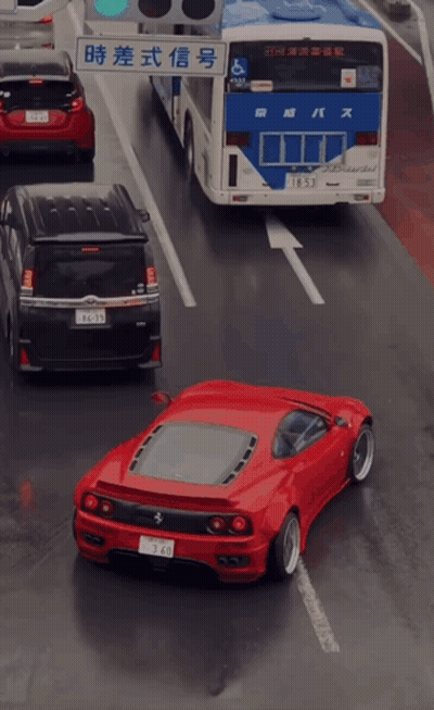 Red Car Driving Next To Bus GIF