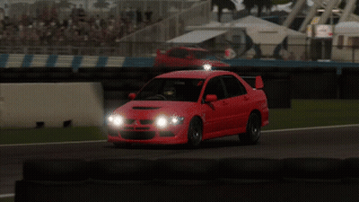 Red Car Driving On Race Track With Headlights On GIF