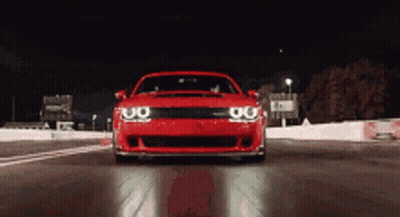 Red Car Driving On Track At Night GIF