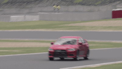 Red Car Driving On Track With Grass GIF