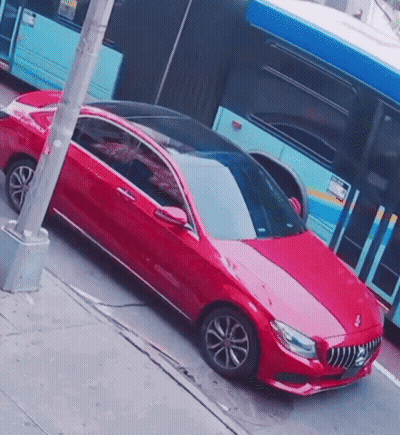 Red Car Parked In Front Of Blue Bus GIF