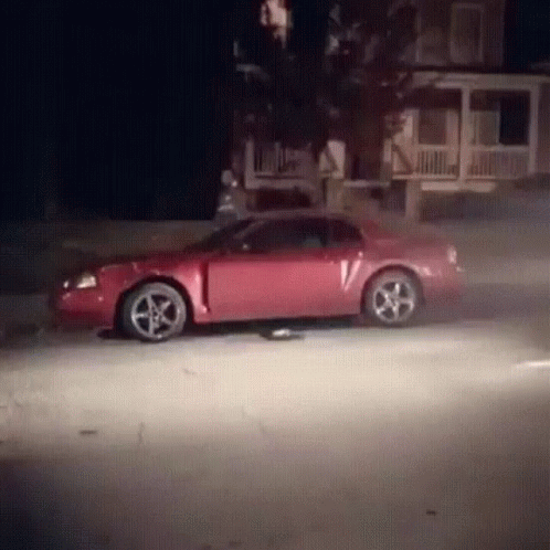 Red Car With V Driving At Night GIF