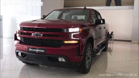 Red Chevrolet Silverado Pickup Truck In Showroom GIF