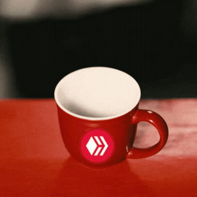 Red Coffee Mug With White Arrow On Red Table GIF