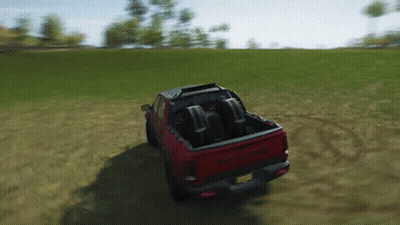 Red Dodge Ram Driving Through Grassy Field GIF