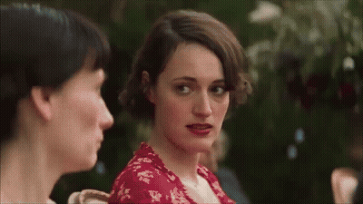 Red Dress Woman Looking At Camera With Another Woman GIF