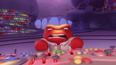 Red-Faced Cartoon Character At Table With Buttons GIF