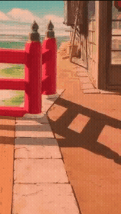 Red Fence On Sidewalk Beside Building GIF