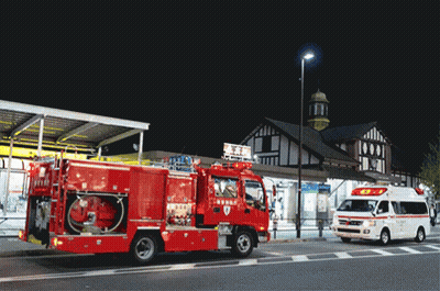 Red Fire Truck And Ambulance Parked In Front Of Building GIF