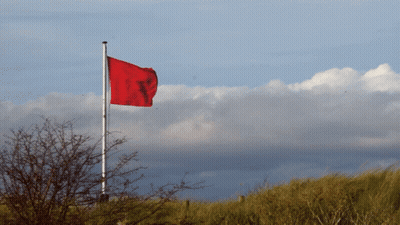 Red Flag Flying In Wind GIF