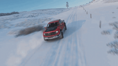 Red Ford Truck Drives Through Snow GIF