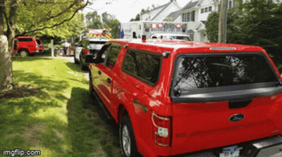 Red Ford Truck Parked Next To White Ambulance GIF