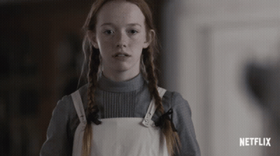 Red Hair Girl Standing In Front Of Netflix Ad GIF