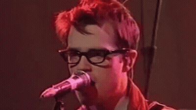 Red Hair Man With Glasses Singing Into Microphone GIF