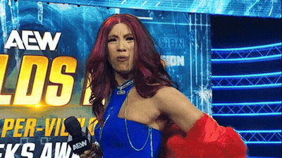 Red Hair Woman In Blue Dress Holding Microphone GIF