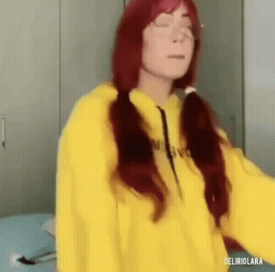 Red Hair Woman In Yellow Hoodie Standing On Bed GIF