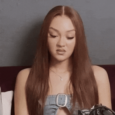 Red Hair Woman On Couch In Denim Top GIF