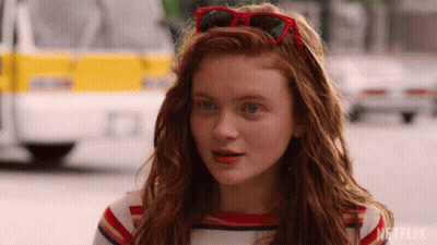 Red-Haired Girl With Sunglasses On Head GIF