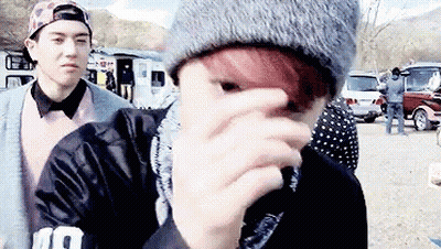 Red-Haired Man Covering Face With Beanie