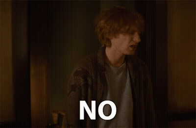 Red-Haired Man Saying No In Dark Room GIF