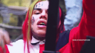 Red Haired Man With Face Tattoo Holding Gun GIF